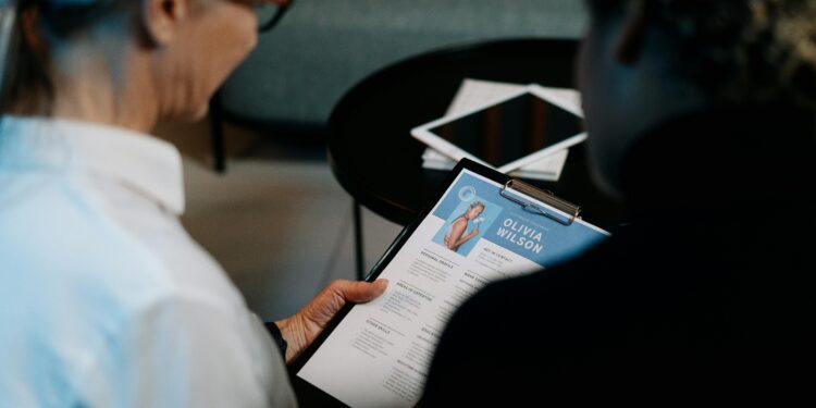 a recruiter is discussing resume with a candidate